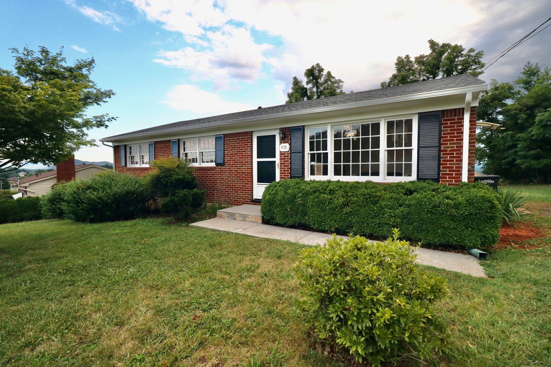 901 Olney Road Vinton, VA 24179 - Photo 10 of 42 a front view of a house with a yard and potted plants
