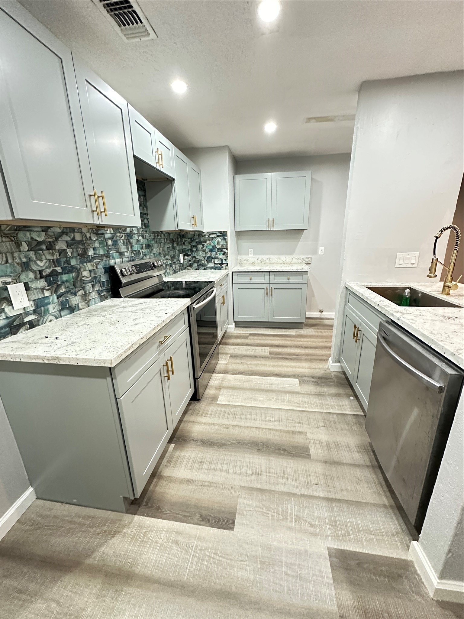 9631 Stockwell Street Houston, TX 77083 - Photo 11 of 23 a kitchen with a stove and a sink