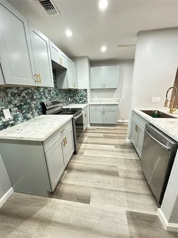 a kitchen with a stove and a sink