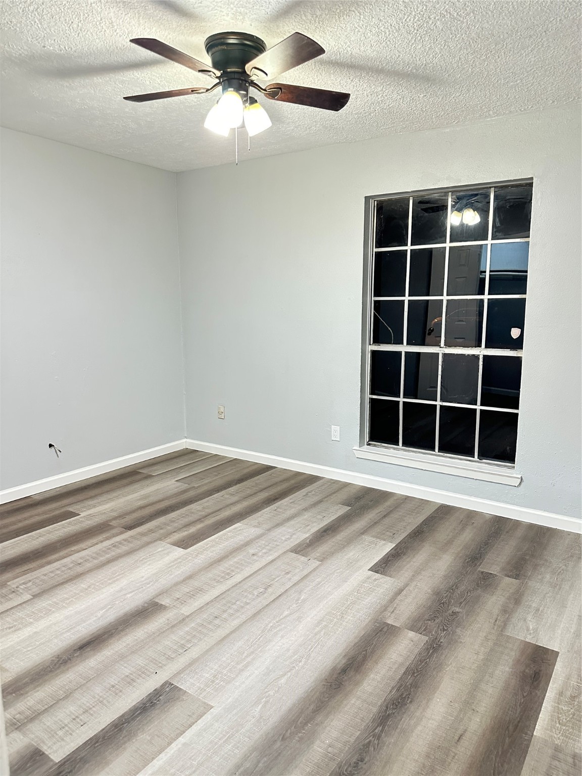 9631 Stockwell Street Houston, TX 77083 - Photo 16 of 23 a view of a livingroom with a ceiling fan and a window