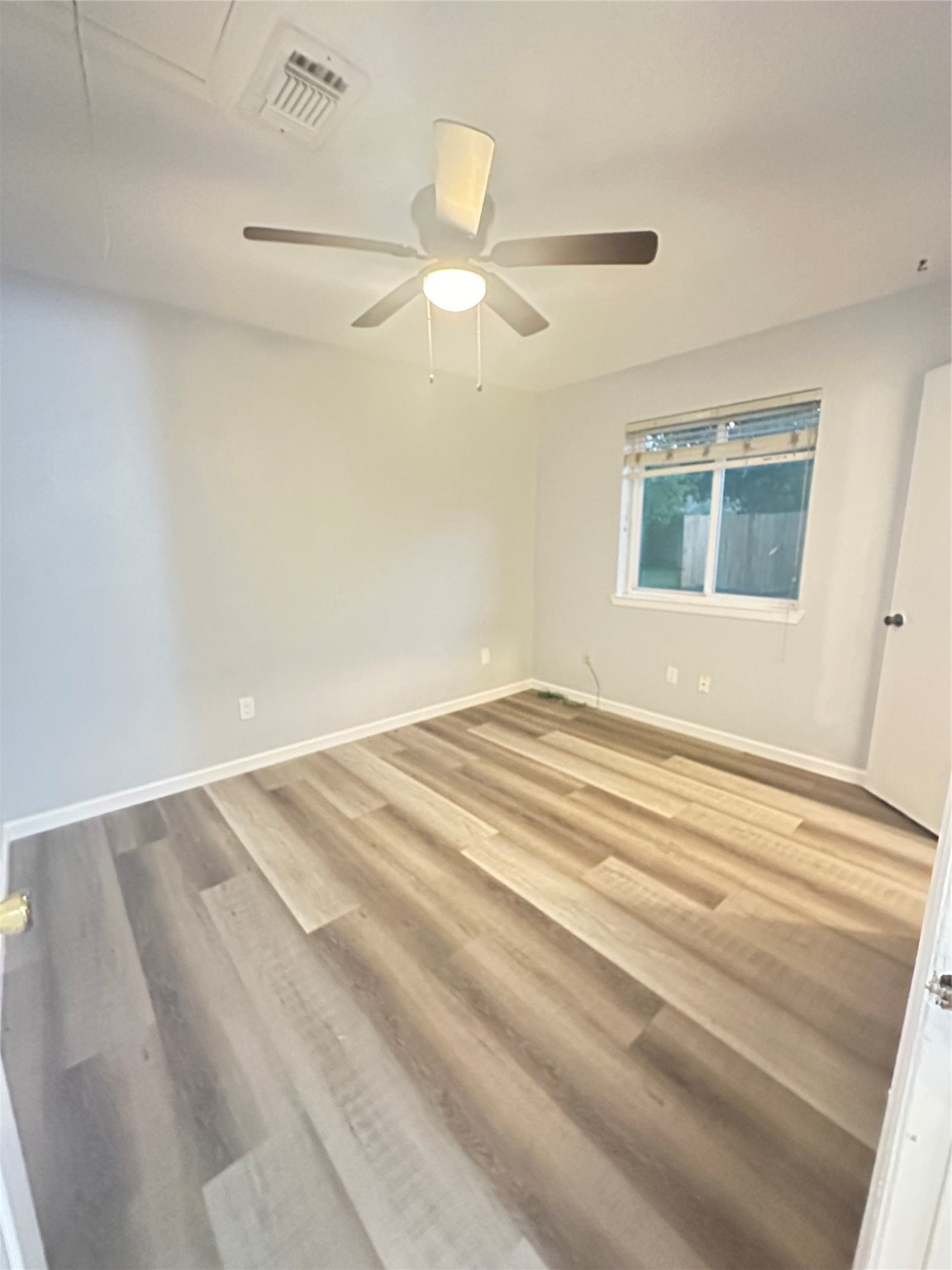 9631 Stockwell Street Houston, TX 77083 - Photo 17 of 23 a view of a room with a ceiling fan and a window