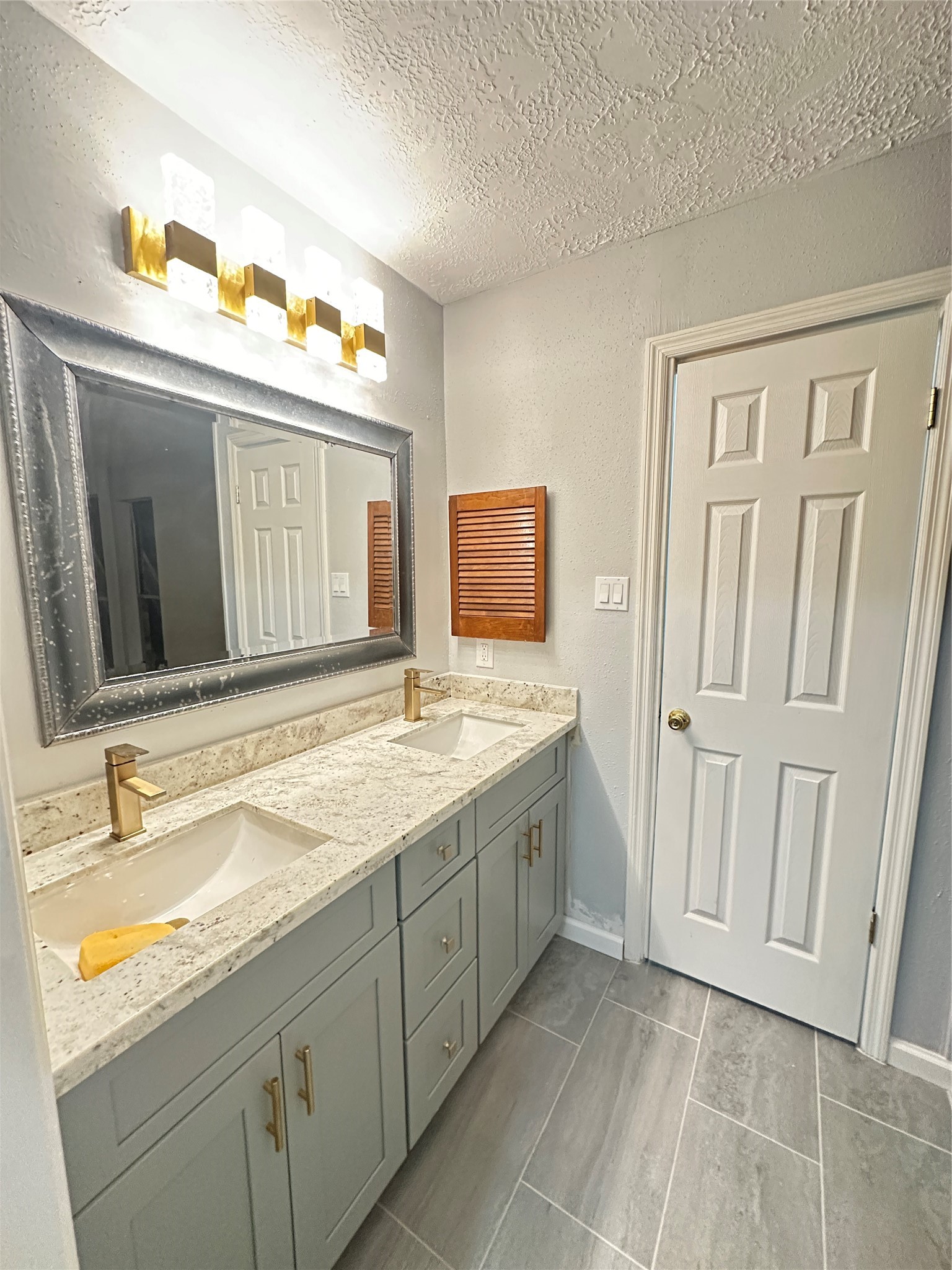 9631 Stockwell Street Houston, TX 77083 - Photo 19 of 23 a bathroom with a sink and a mirror