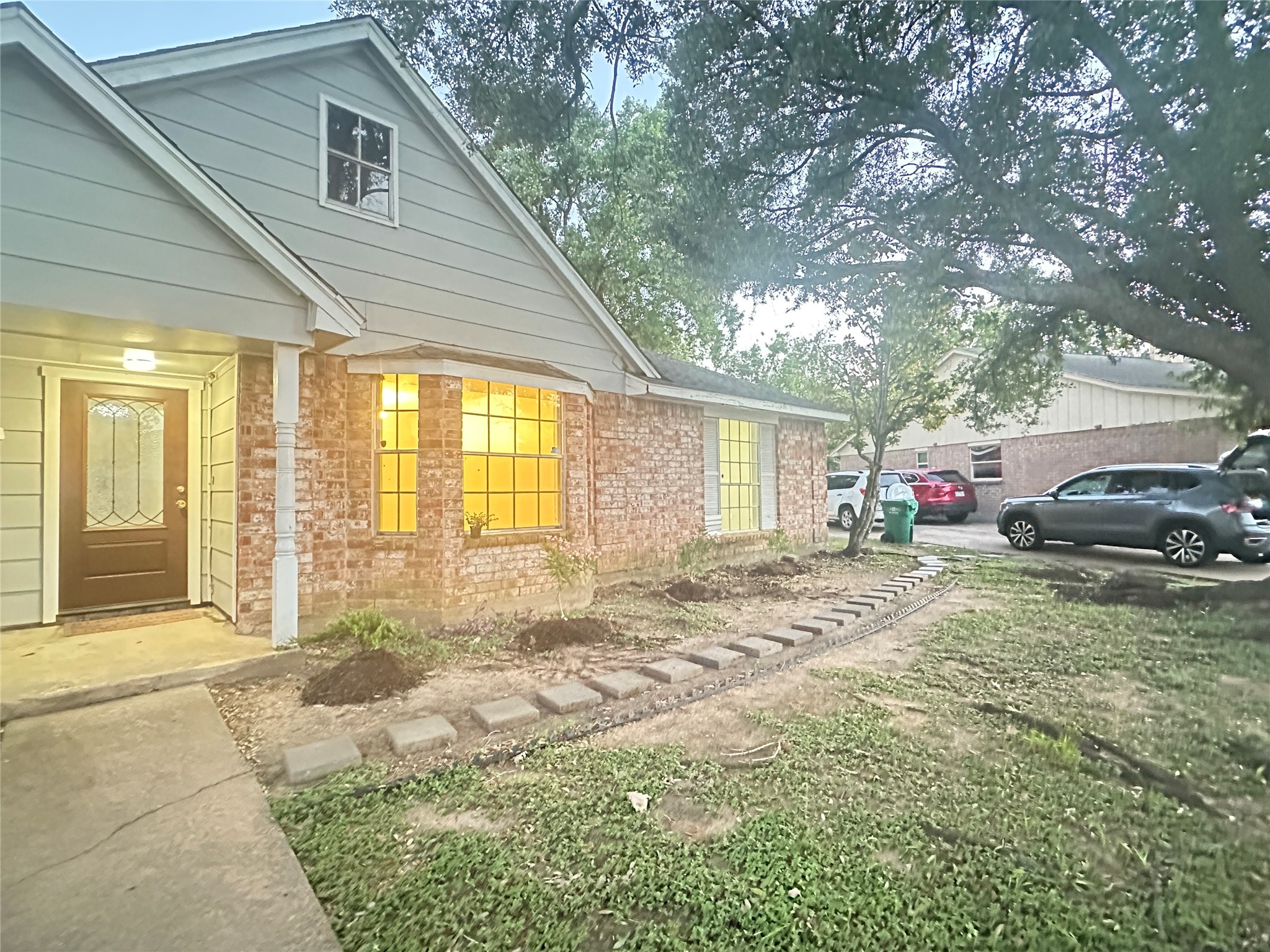 9631 Stockwell Street Houston, TX 77083 - Photo 2 of 23 a view of a house with a patio and a yard