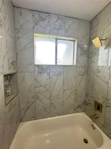 a bathroom with a bathtub and a shower