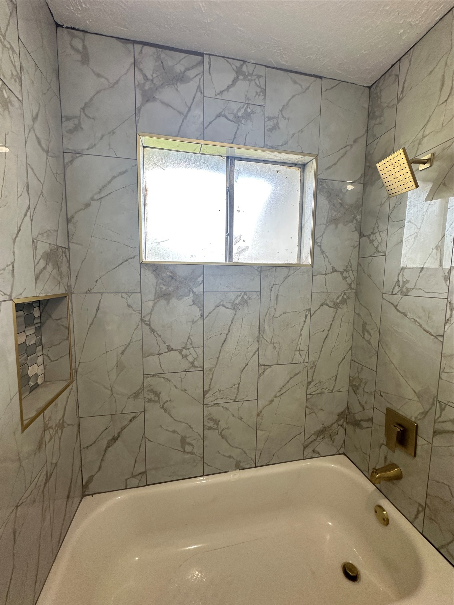 9631 Stockwell Street Houston, TX 77083 - Photo 21 of 23 a bathroom with a bathtub and a shower