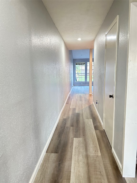 9631 Stockwell Street Houston, TX 77083 - Photo 4 of 23 a view of a hallway with wooden floor and a bathroom