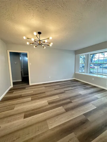 a view of a room with a ceiling fan and a chandelier fan