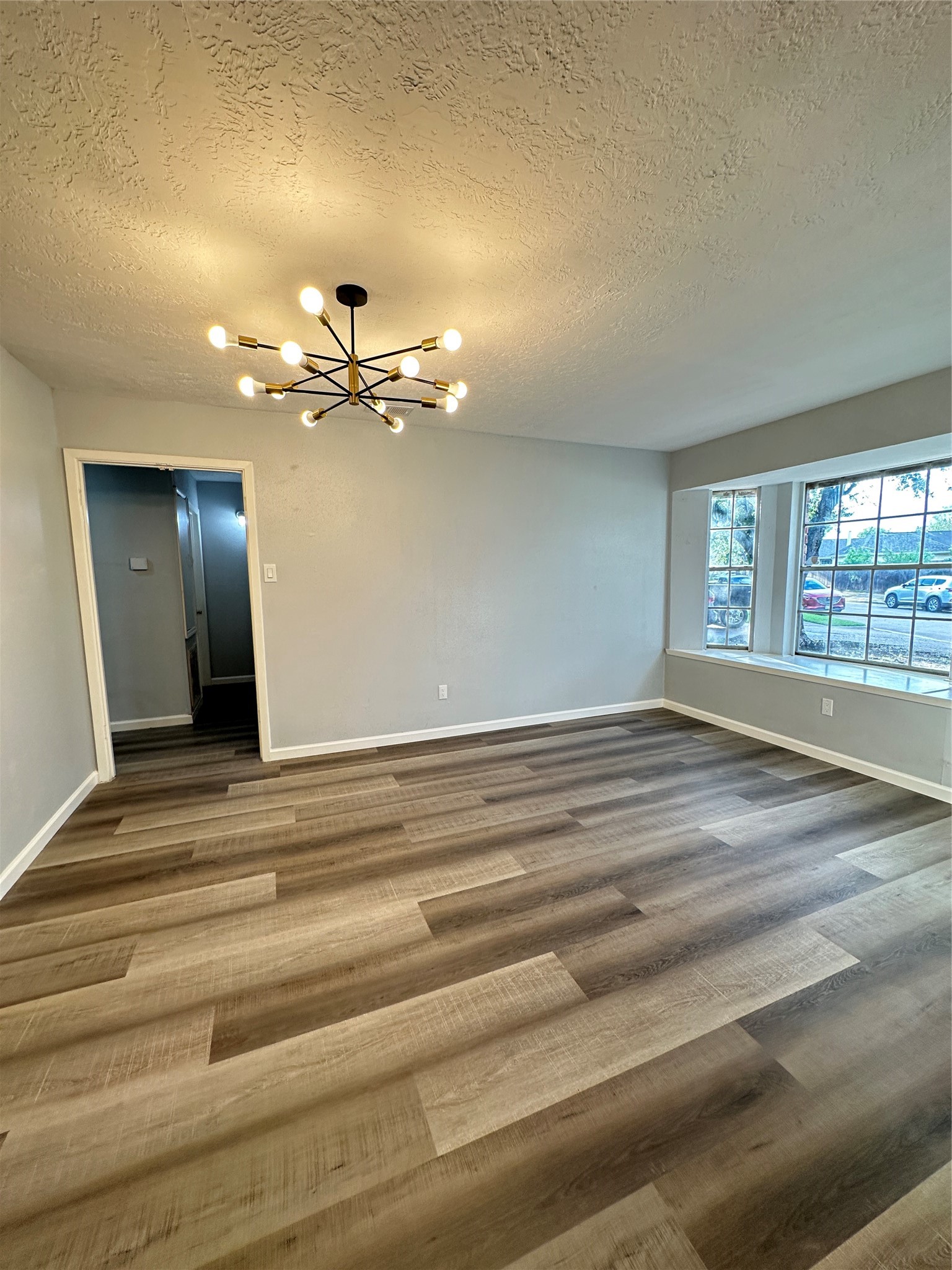 9631 Stockwell Street Houston, TX 77083 - Photo 6 of 23 a view of a room with a ceiling fan and a chandelier fan