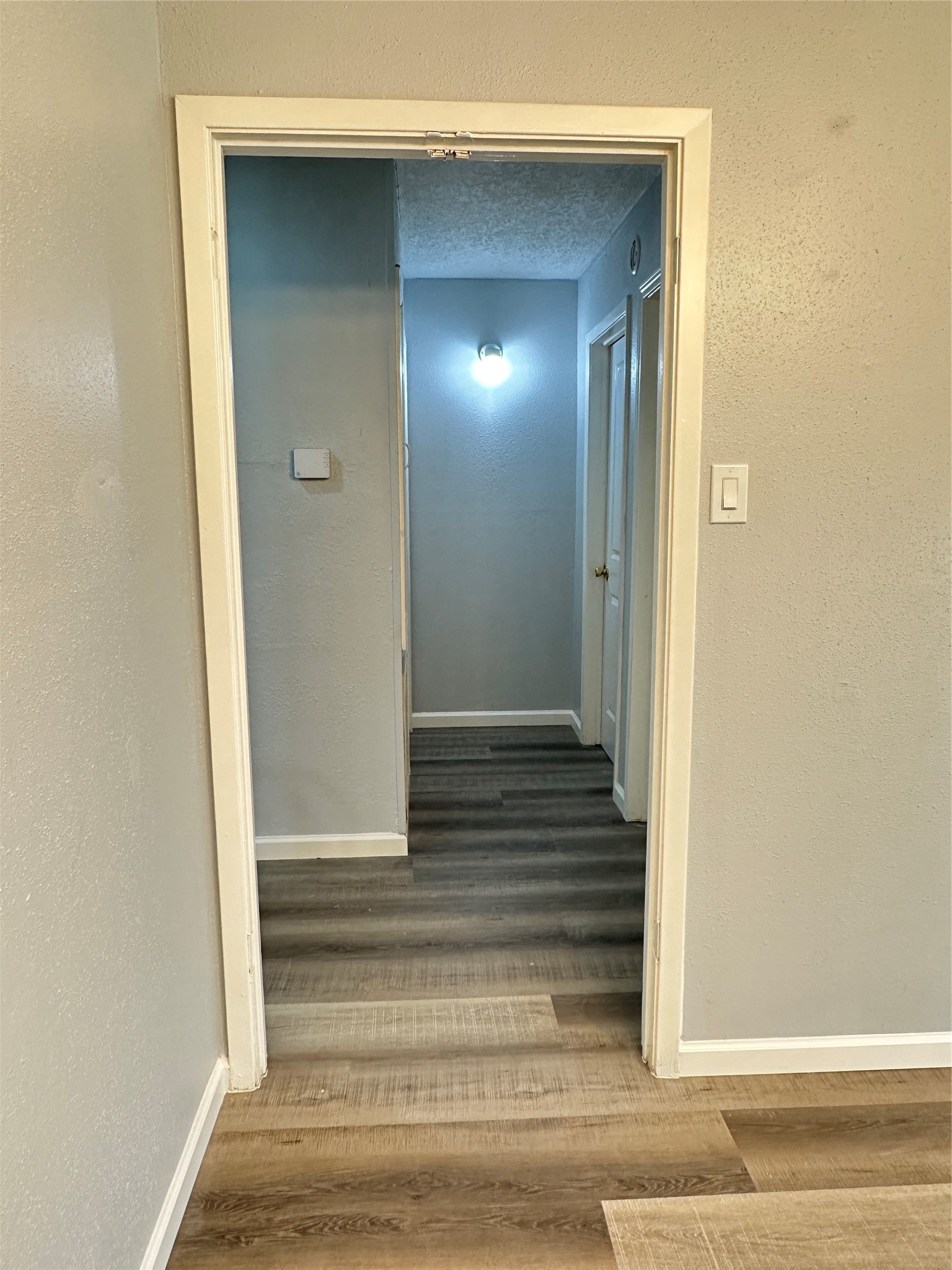 9631 Stockwell Street Houston, TX 77083 - Photo 7 of 23 a view of a hallway with wooden floor