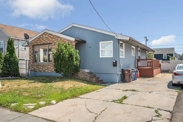 a view of a house with backyard and sitting area