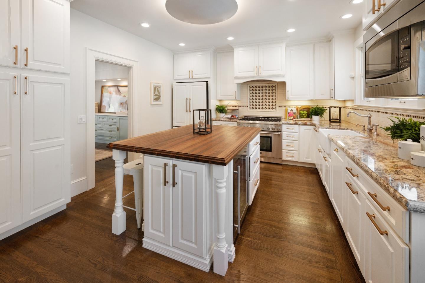 170 Warren Road San Mateo, CA 94401 - Photo 25 of 56 a kitchen with stainless steel appliances granite countertop a stove top oven a sink dishwasher and a refrigerator with wooden floor