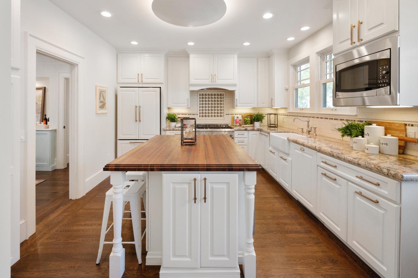 170 Warren Road San Mateo, CA 94401 - Photo 28 of 56 a kitchen with kitchen island granite countertop a sink counter top space appliances and cabinets