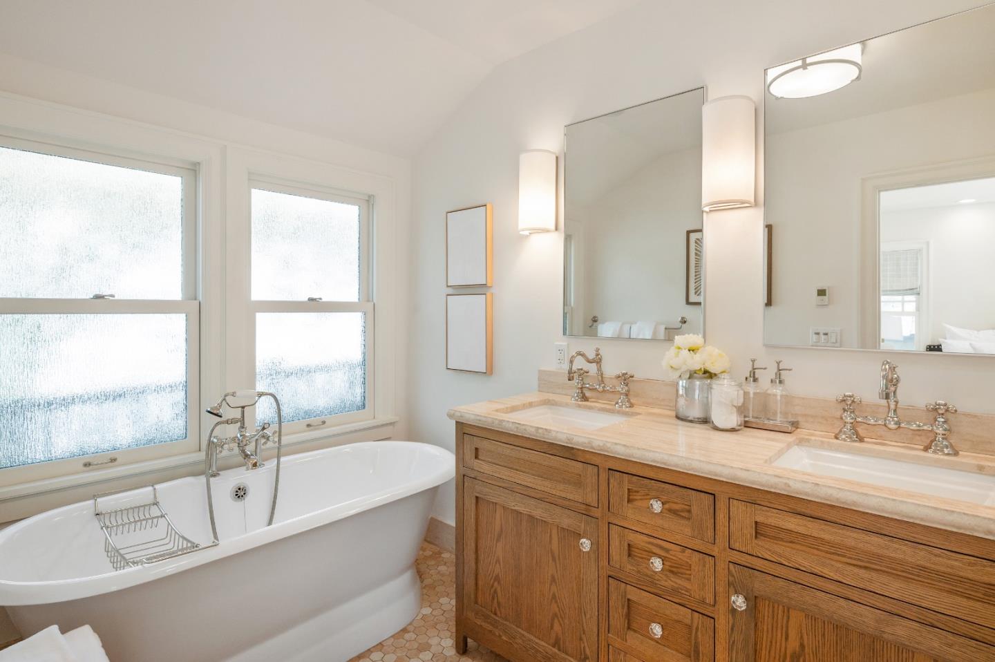 170 Warren Road San Mateo, CA 94401 - Photo 38 of 56 a bathroom with a granite countertop tub sink and mirror