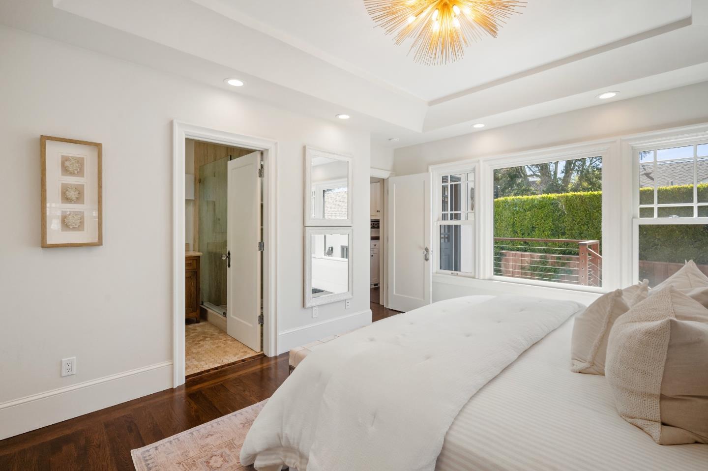 170 Warren Road San Mateo, CA 94401 - Photo 42 of 56 a bedroom with a bed and a chandelier