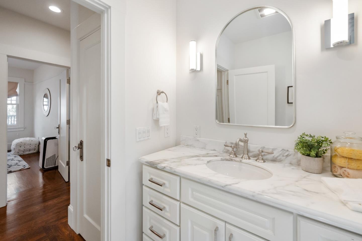 170 Warren Road San Mateo, CA 94401 - Photo 44 of 56 a en suite bathroom with a granite countertop sink and a mirror