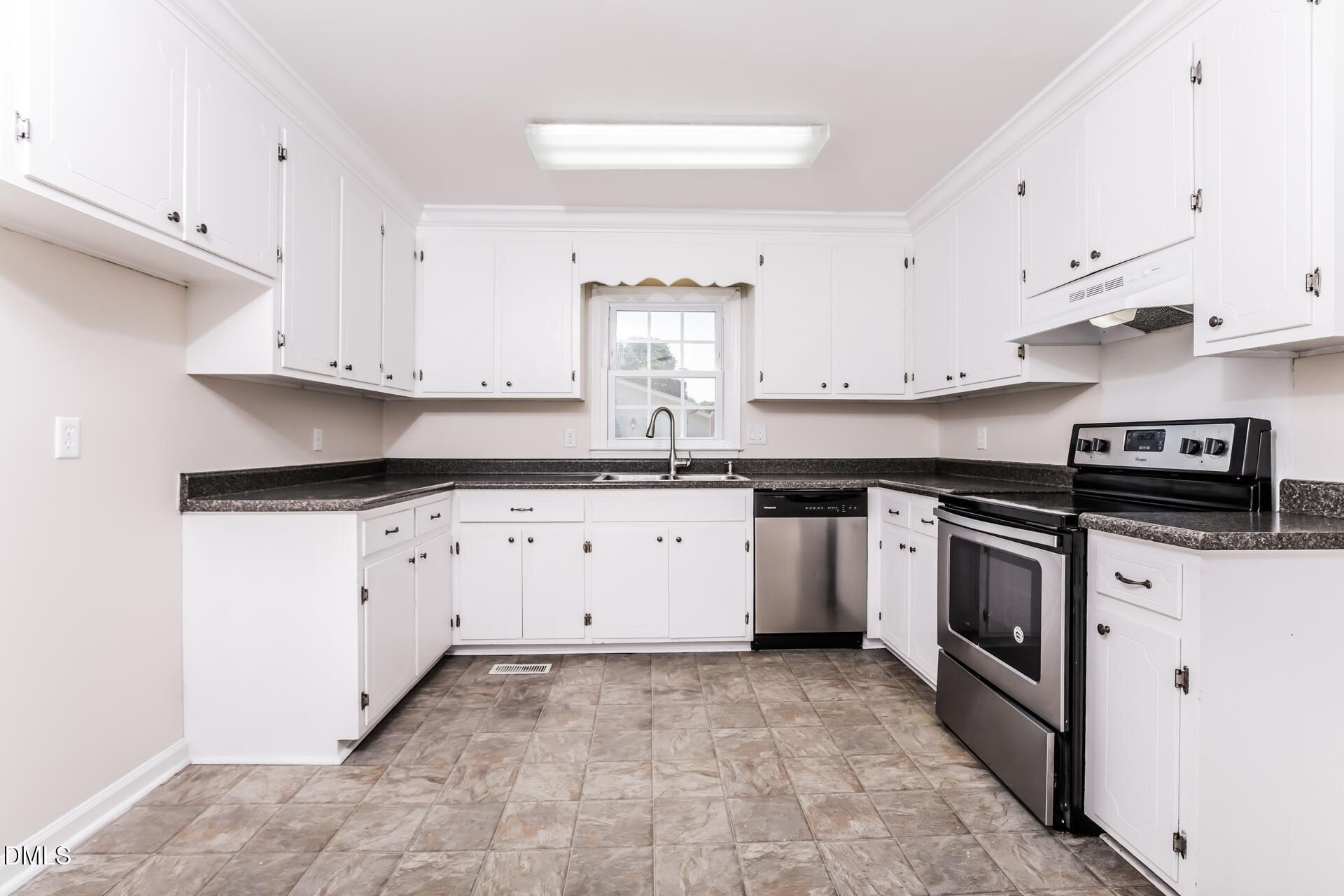 870 Abbott Road Henderson, NC 27537 - Photo 2 of 20 a kitchen with granite countertop a stove sink and cabinets