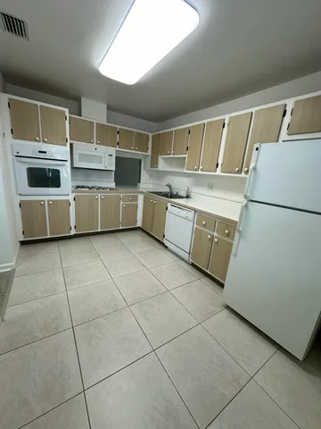 a kitchen with stainless steel appliances a stove a sink and a refrigerator