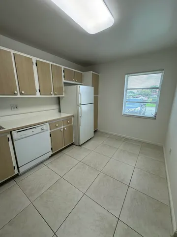 a kitchen with a stove a sink and a refrigerator