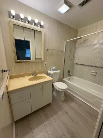 a bathroom with a sink a toilet and bathtub