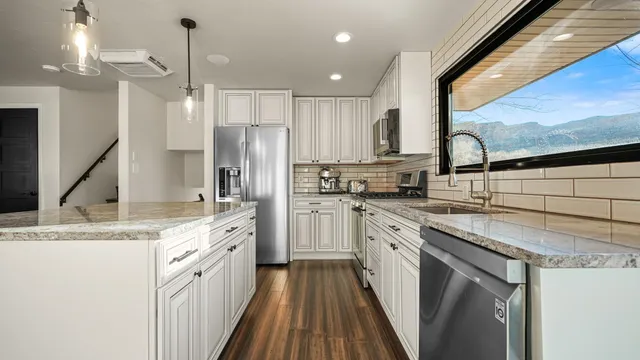 a kitchen with a sink stove and refrigerator