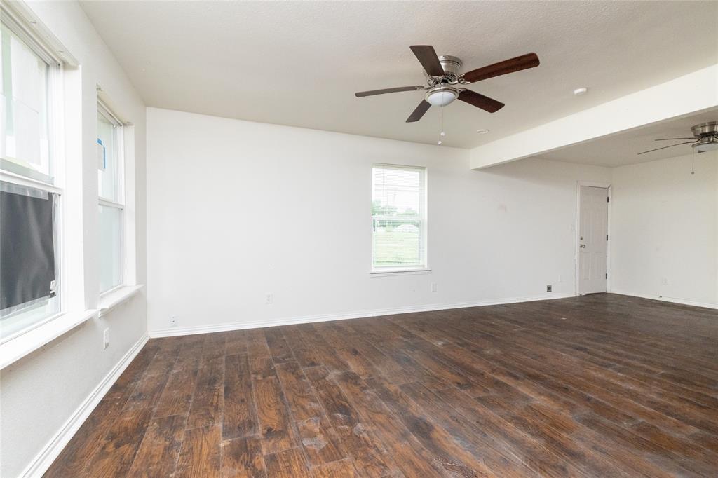 805 East Belt Line Road DeSoto, TX 75115 - Photo 4 of 15 a view of empty room with wooden floor and fan