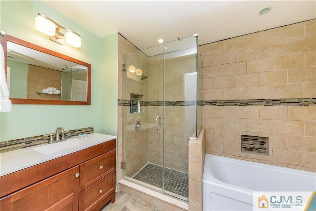 1 Colonial Road Roselle, NJ 07203 - Photo 14 of 35 a bathroom with a shower sink and mirror