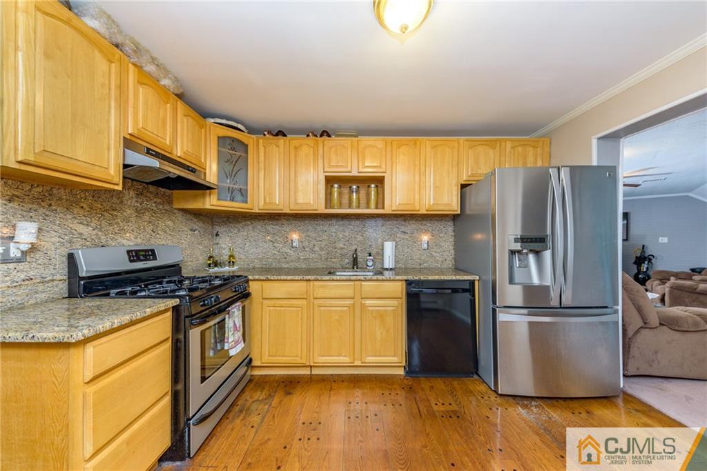 1 Colonial Road Roselle, NJ 07203 - Photo 8 of 35 a kitchen with stainless steel appliances granite countertop a refrigerator a stove and a sink