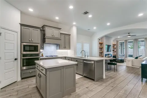 a kitchen with cabinets a sink and appliances