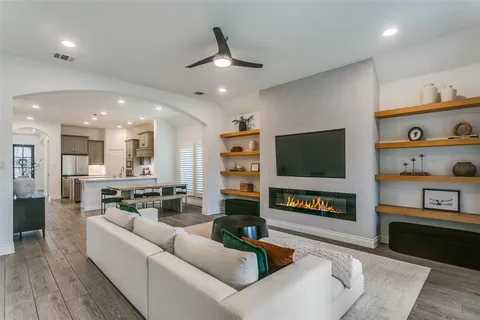 a living room with fireplace furniture and a flat screen tv