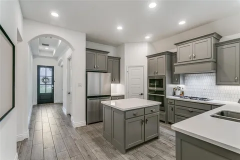 a kitchen with a sink stainless steel appliances and cabinets