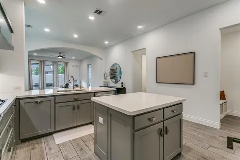 a kitchen with a sink cabinets and wooden floor