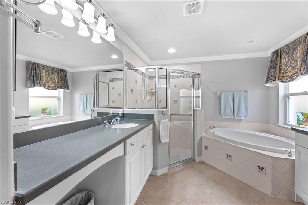 19724 Villa Rosa Loop Estero, FL 33967 - Photo 25 of 50 a spacious bathroom with a sink a large mirror and a bathtub