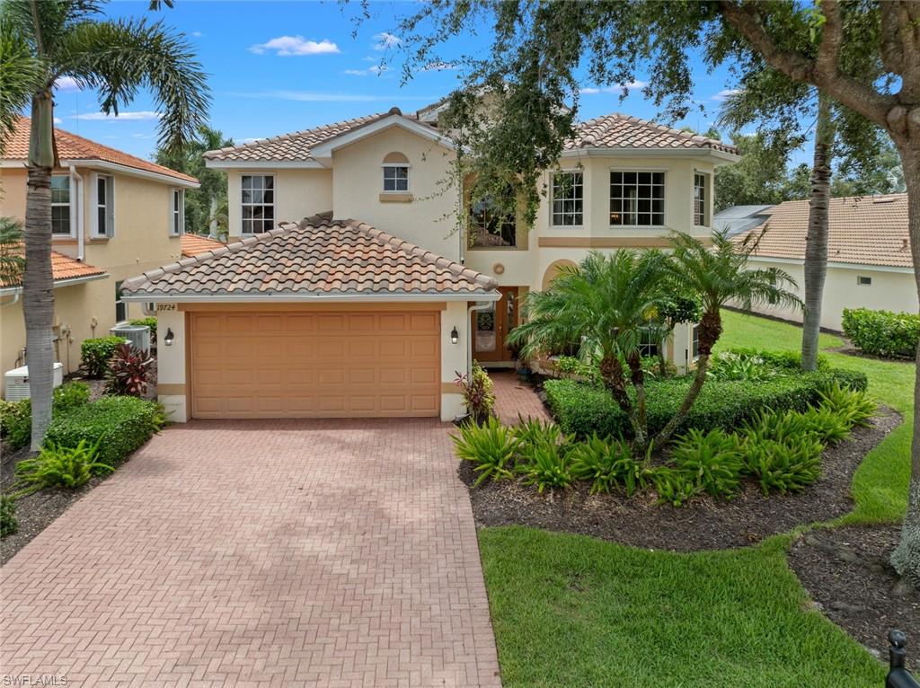 19724 Villa Rosa Loop Estero, FL 33967 - Photo 4 of 50 a front view of a house with a yard and garage