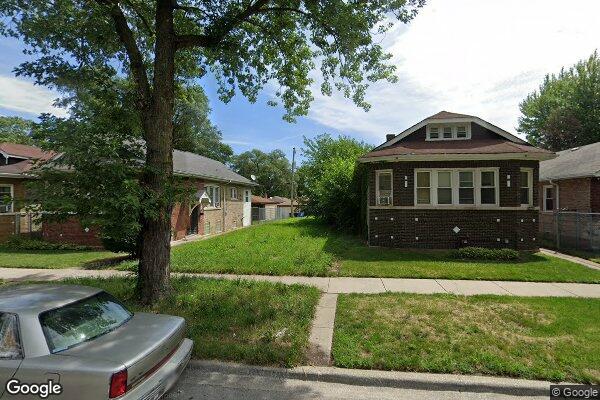 12251 South Yale Avenue Chicago, IL 60628 - Photo 1 of 1 a front view of a house with a yard and garage