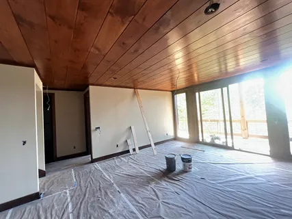 a kitchen with white cabinets and refrigerator