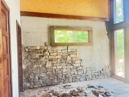 a living room with furniture and large windows