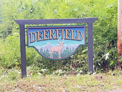 a view of a wooden house with a yard