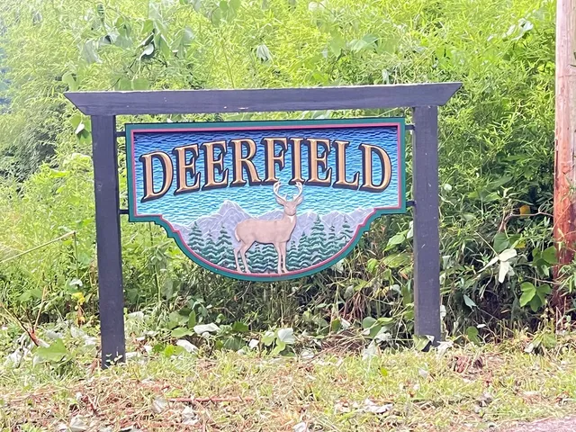 a view of a wooden house with a yard