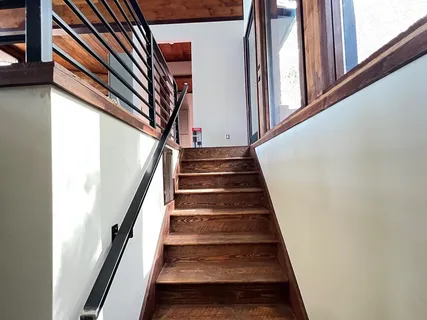 a view of room with wooden floor and windows
