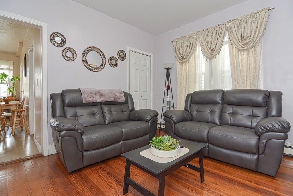 110 Everett Street Boston, MA 02128 - Photo 13 of 41 a living room with furniture and a wooden floor