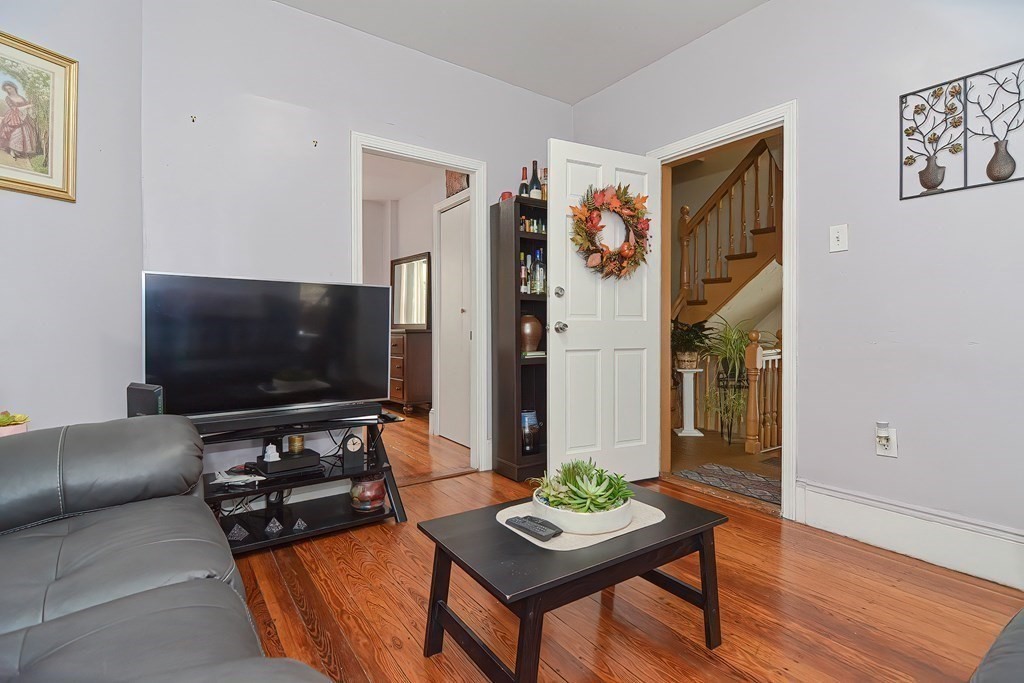 110 Everett Street Boston, MA 02128 - Photo 14 of 41 a living room with furniture and a flat screen tv