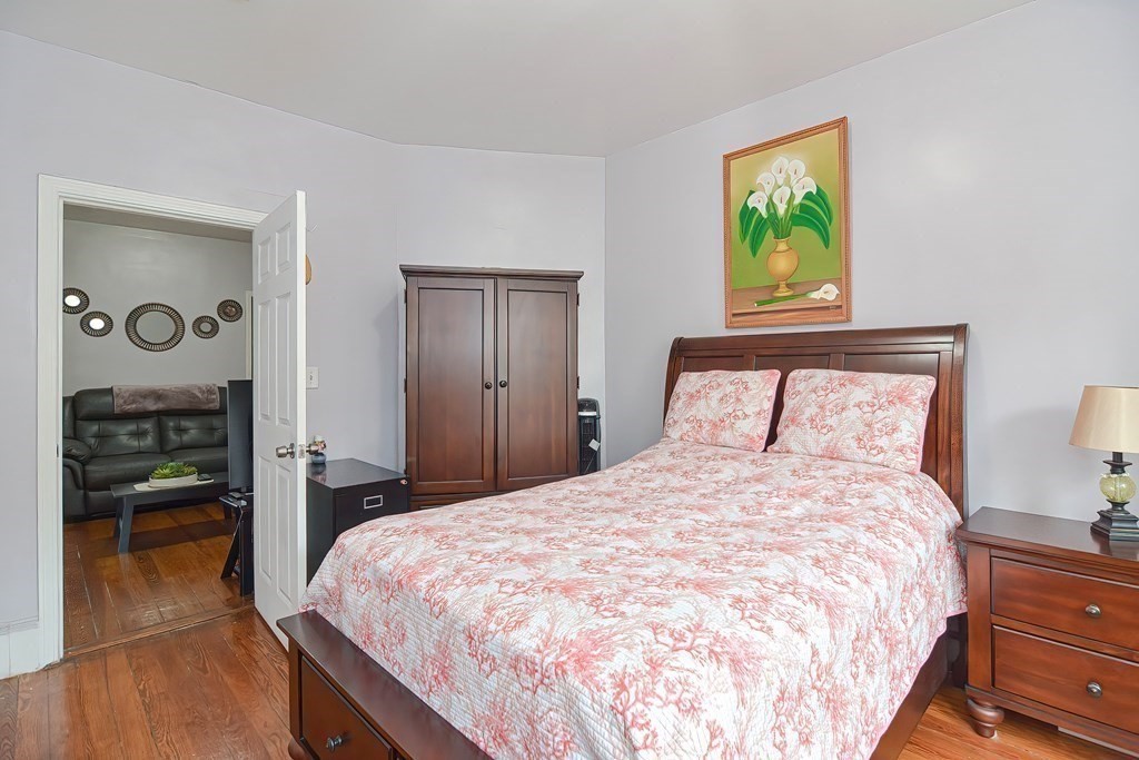 110 Everett Street Boston, MA 02128 - Photo 16 of 41 a large bed in a bedroom next to a window