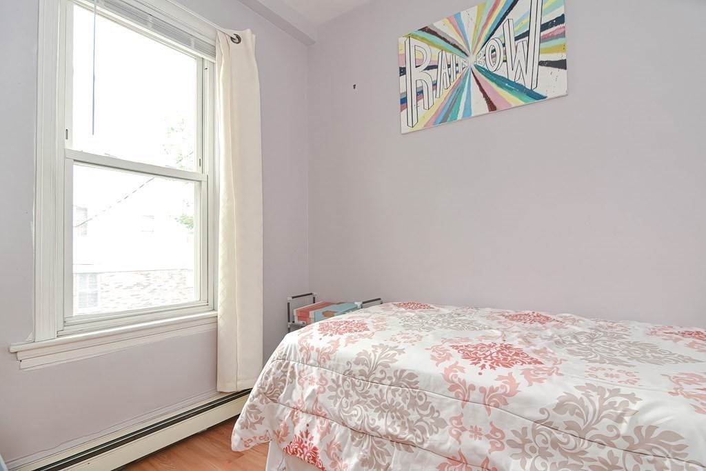 110 Everett Street Boston, MA 02128 - Photo 17 of 41 a bedroom with a bed and a window