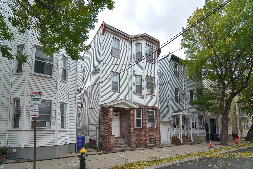 110 Everett Street Boston, MA 02128 - Photo 2 of 41 a view of a white house with large tree and many windows