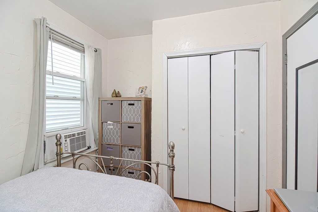110 Everett Street Boston, MA 02128 - Photo 22 of 41 a bedroom with a large bed and a window