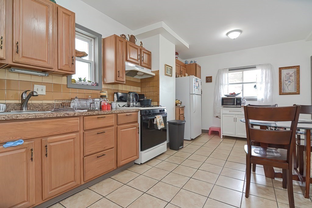 110 Everett Street Boston, MA 02128 - Photo 23 of 41 a kitchen with stainless steel appliances granite countertop a refrigerator sink and cabinets