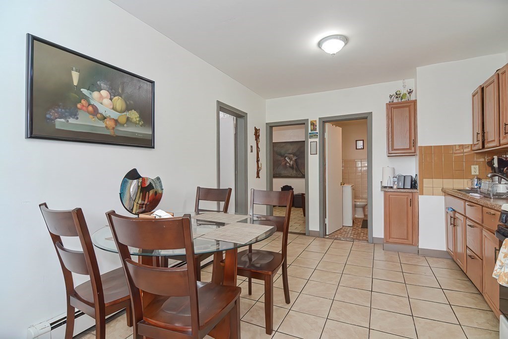110 Everett Street Boston, MA 02128 - Photo 24 of 41 a view of a dining room with furniture and a kitchen