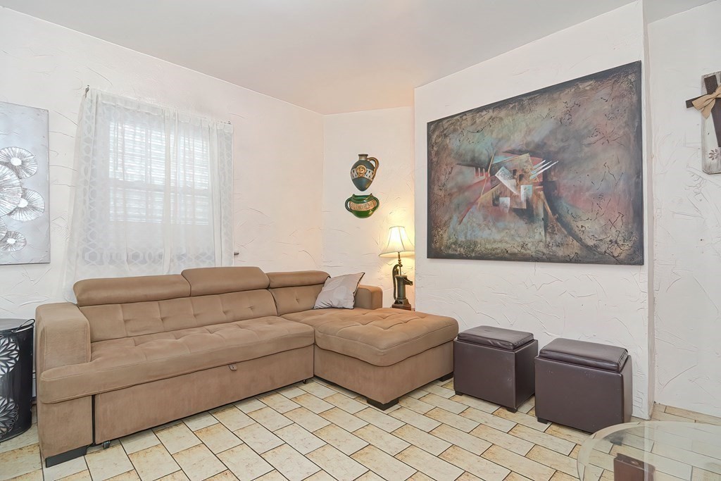 110 Everett Street Boston, MA 02128 - Photo 25 of 41 a living room with couches and a painting on the wall