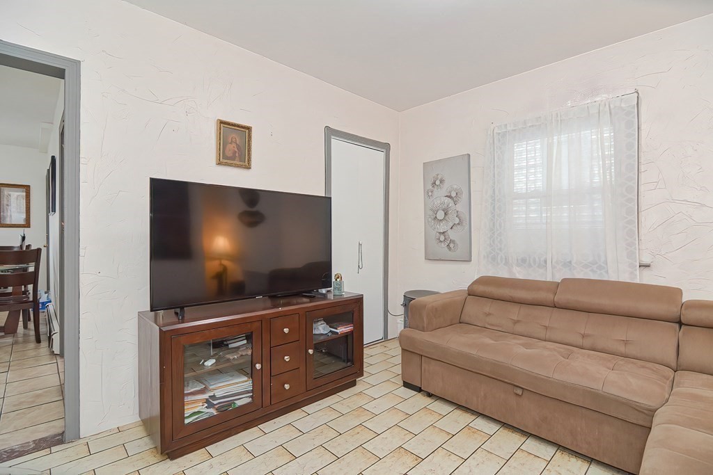 110 Everett Street Boston, MA 02128 - Photo 26 of 41 a living room with furniture and a flat screen tv