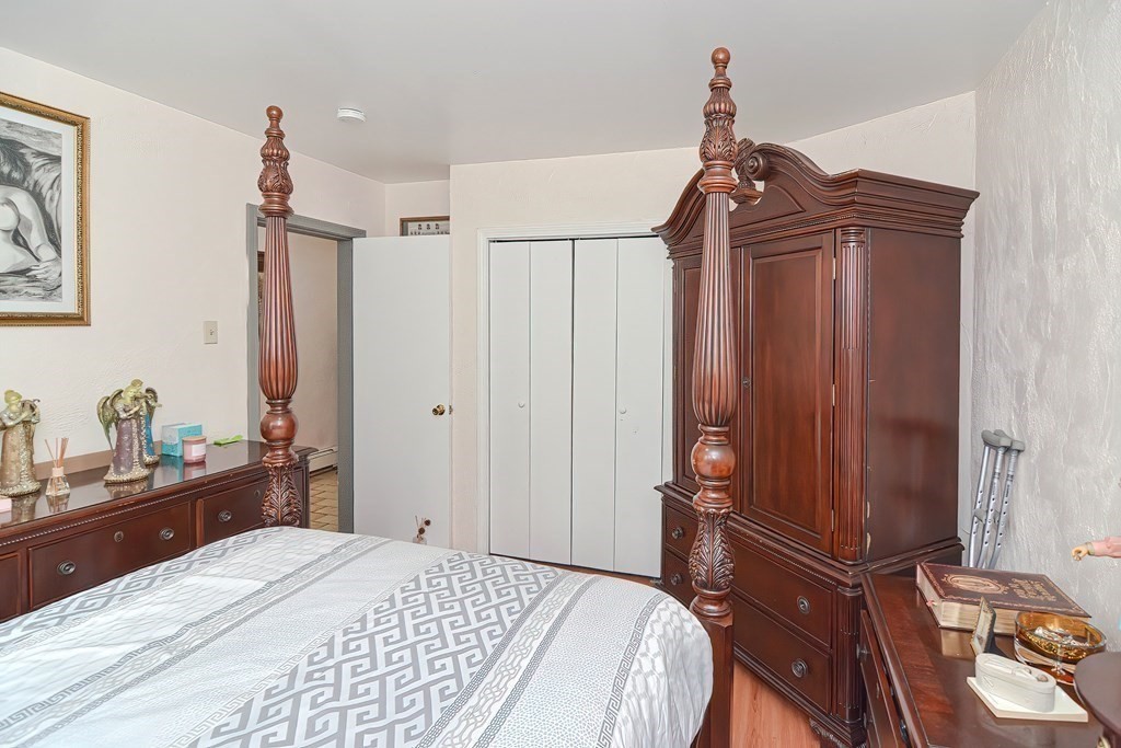110 Everett Street Boston, MA 02128 - Photo 28 of 41 a bedroom with a bed and a dresser